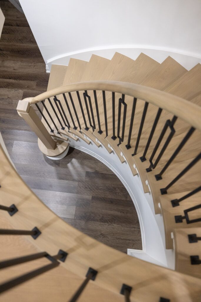 Curved staircase in a custom home renovation