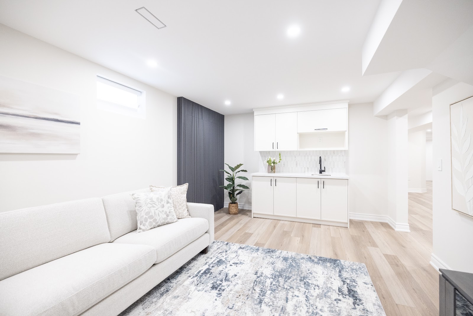 Basement bar area with white custom cabinetry and dark slat accent wall, Hamilton