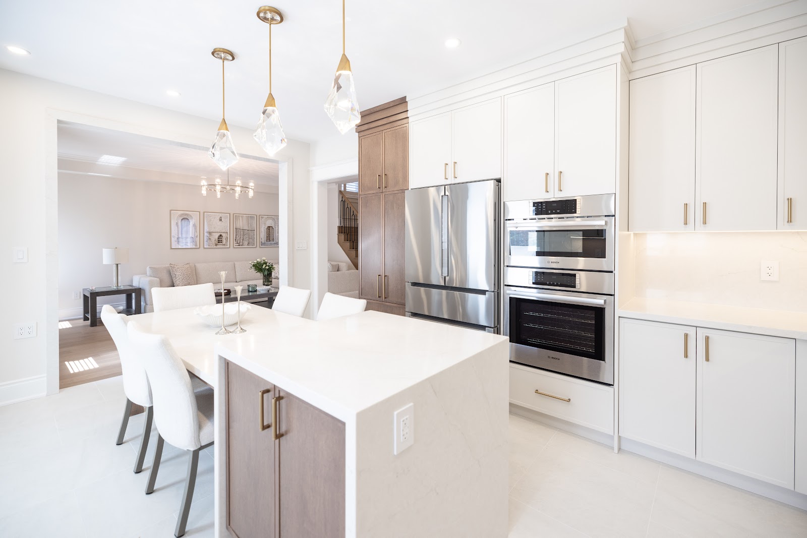 Modern renovated kitchen with waterfall island, built-in ovens and pendant lights open to the living room, Hamilton home renovation